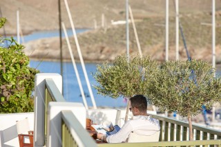 gallery porto klaras man sitting at the sea view veranda